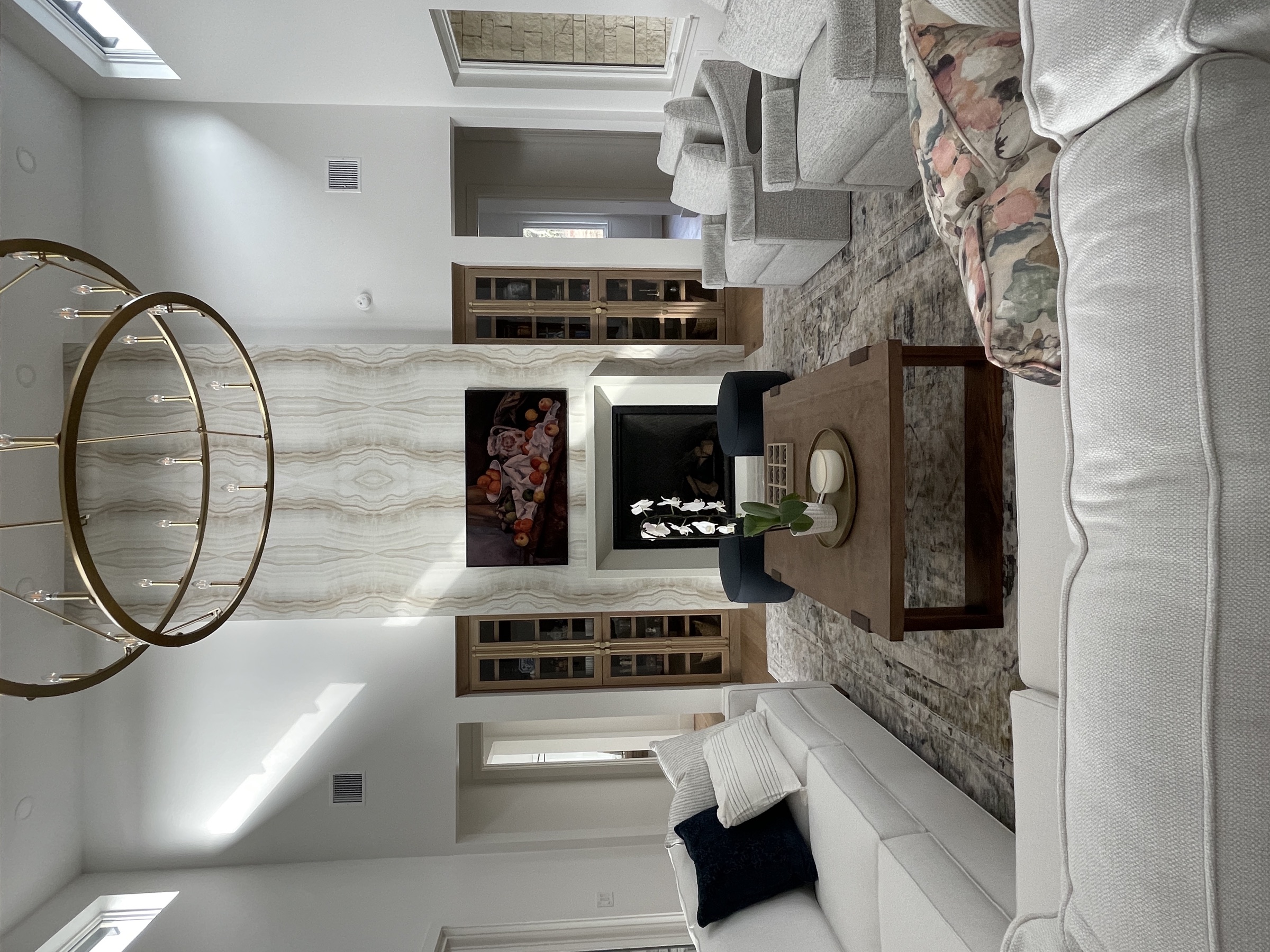 Tranquil transitional living room with marble fireplace by Defined Interiors