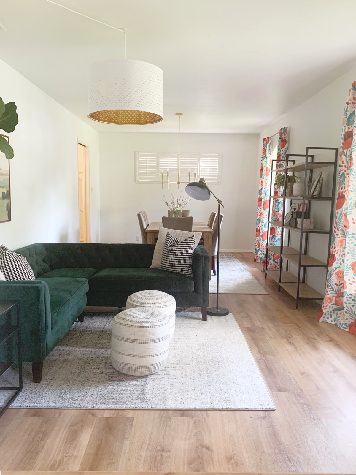 Lounge with emerald velvet sofa and patterned drapery