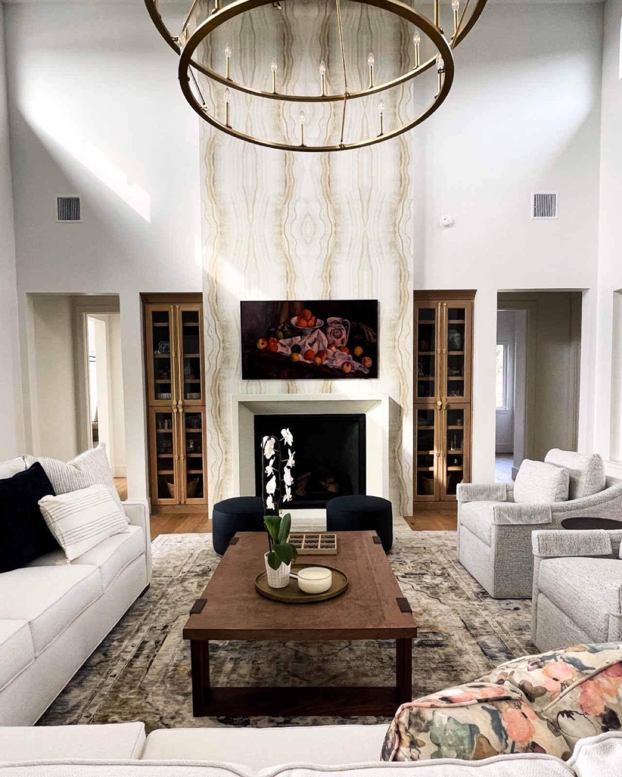 Tranquil Transitional living room — statement fireplace and ring chandelier