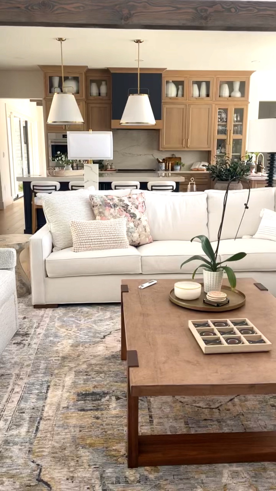 Great room with white sofas and patterned rug