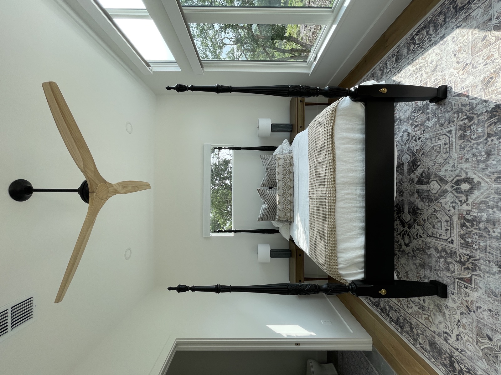 Bedroom with four-poster bed and wood ceiling fan