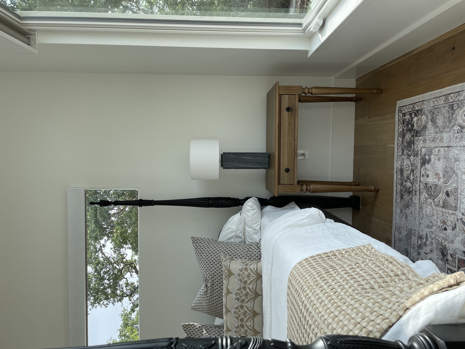 Guest bedroom with layered quilt and rust throw