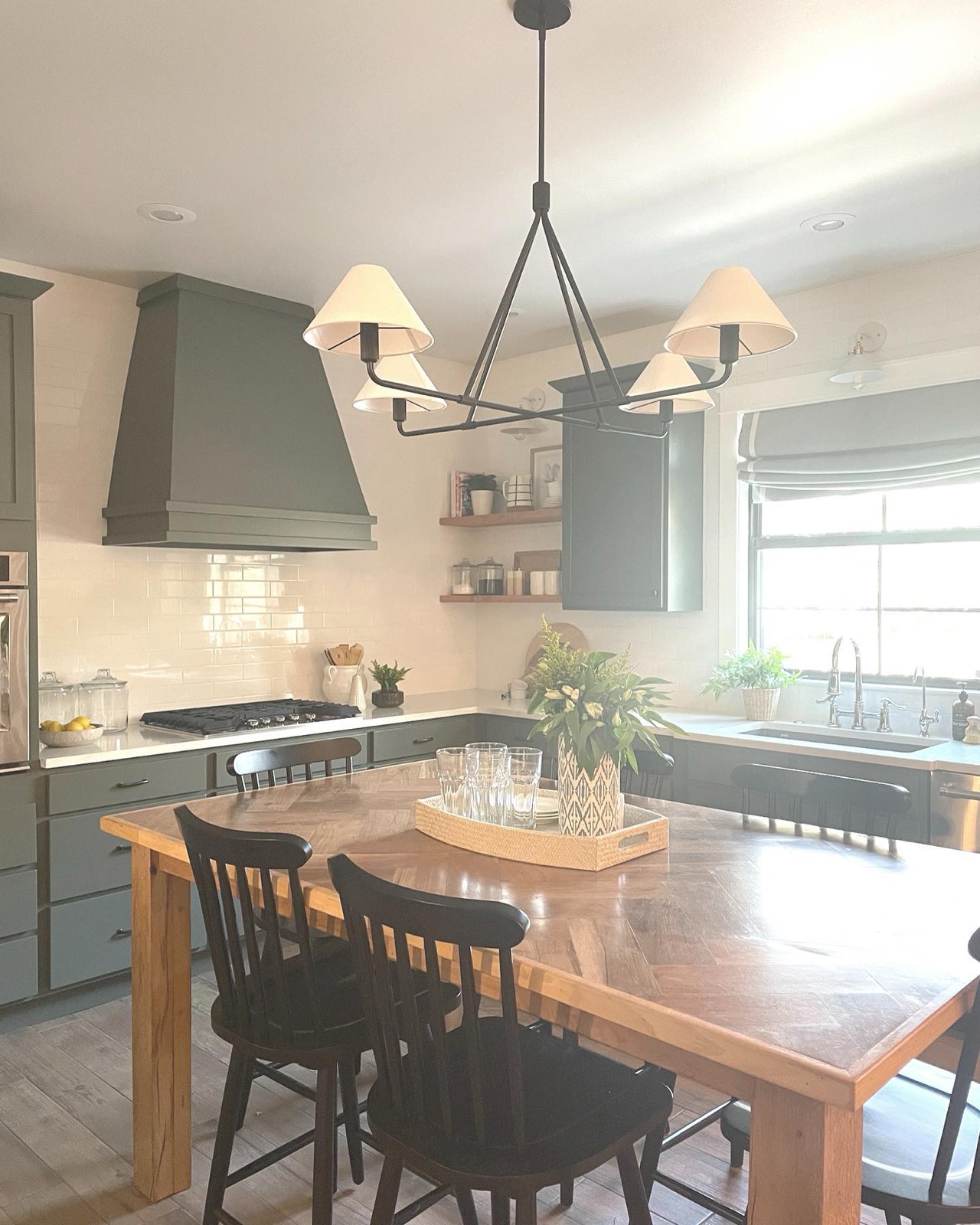 Kitchen with farmhouse dining table and iron chandelier