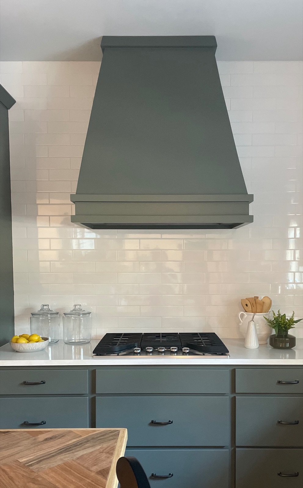 Custom sage vent hood over the cooktop