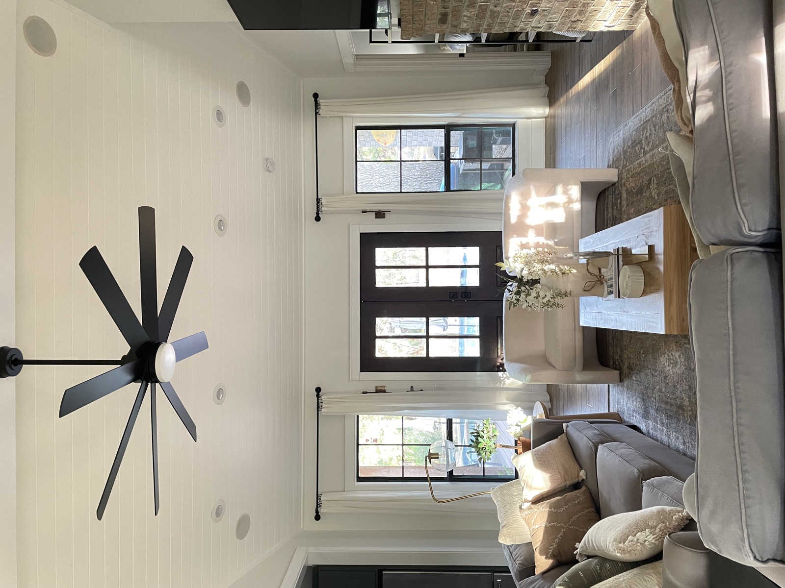 Living room with black windmill fan and french doors